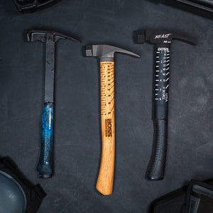 Steel framing hammer sitting on a concrete floor showing the built-in squaring system and degree markers to quick mark various angles on the fly