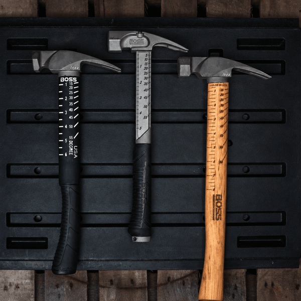 Titanium Framing Hammers with built-in squaring system for straight lines and marking angles on the go. This hammer is in a construction site leaning against a wall